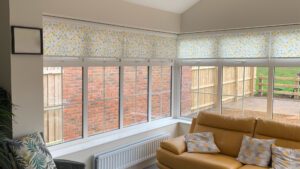 a conservatory with roller blinds on all the windows