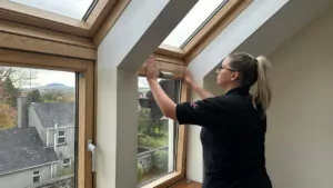 Why Do Customers Love Village Blinds and Shutters? Survey Reveals: Over 98% Rate Our Service as Excellent! A tilt and turn window being measured for blinds in a home in northern ireland