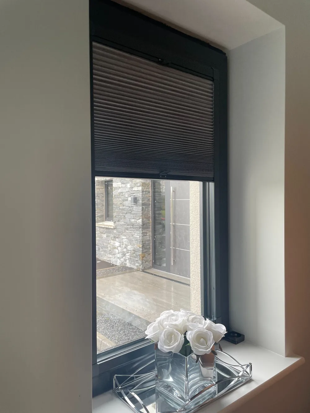 Real Village installation of a dark grey cellular Perfect Fit blind on a tall narrow window
