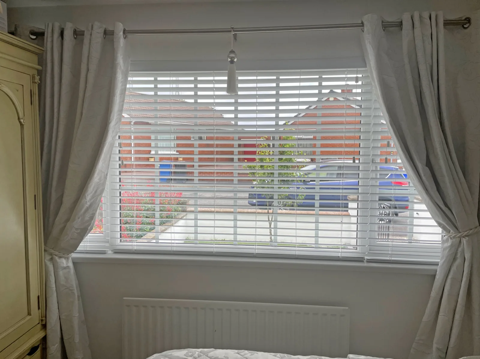 Light wooden blinds fitted in a bedroom