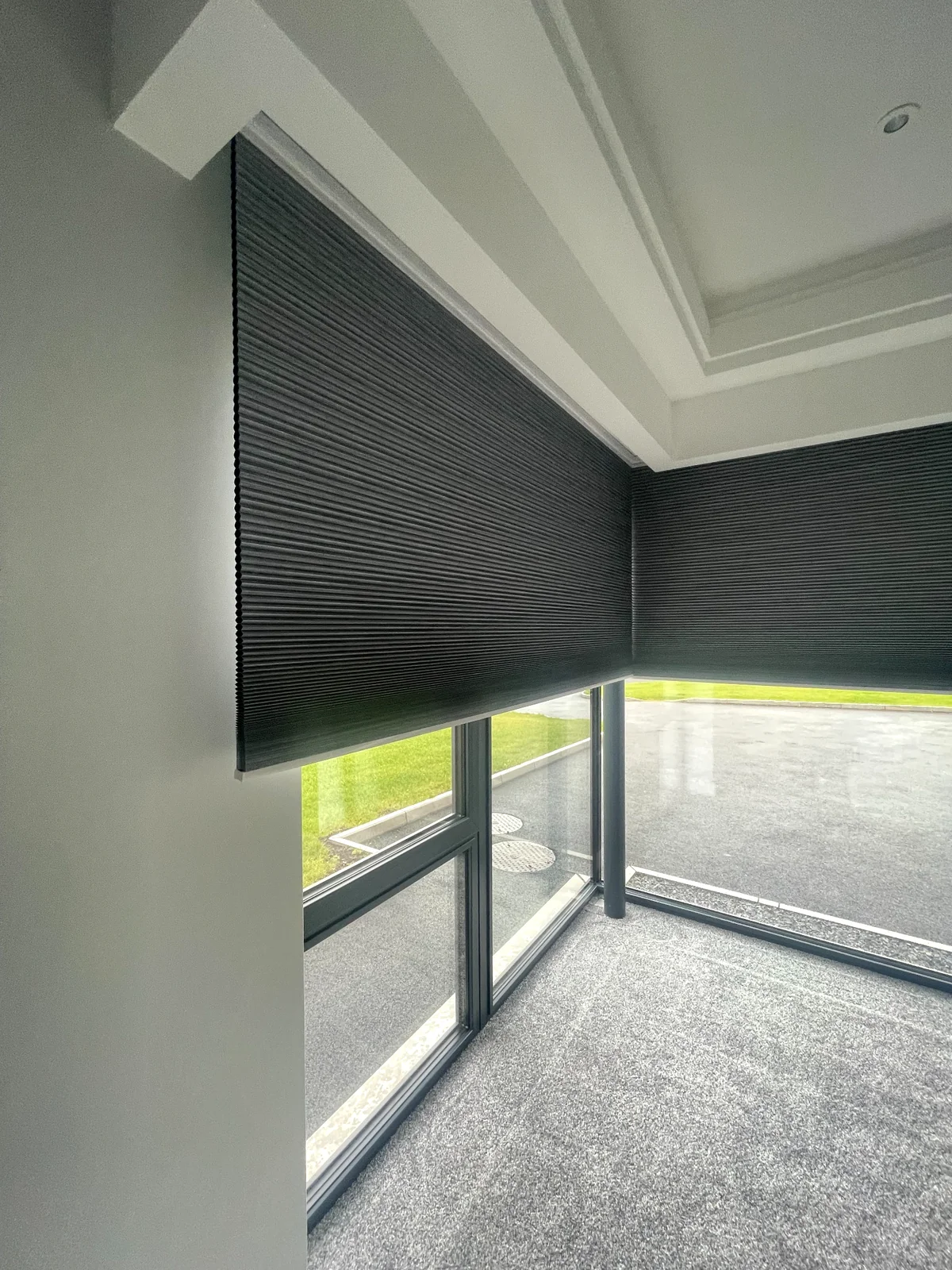 Cellular blinds fitted around corner glazing in a modern room