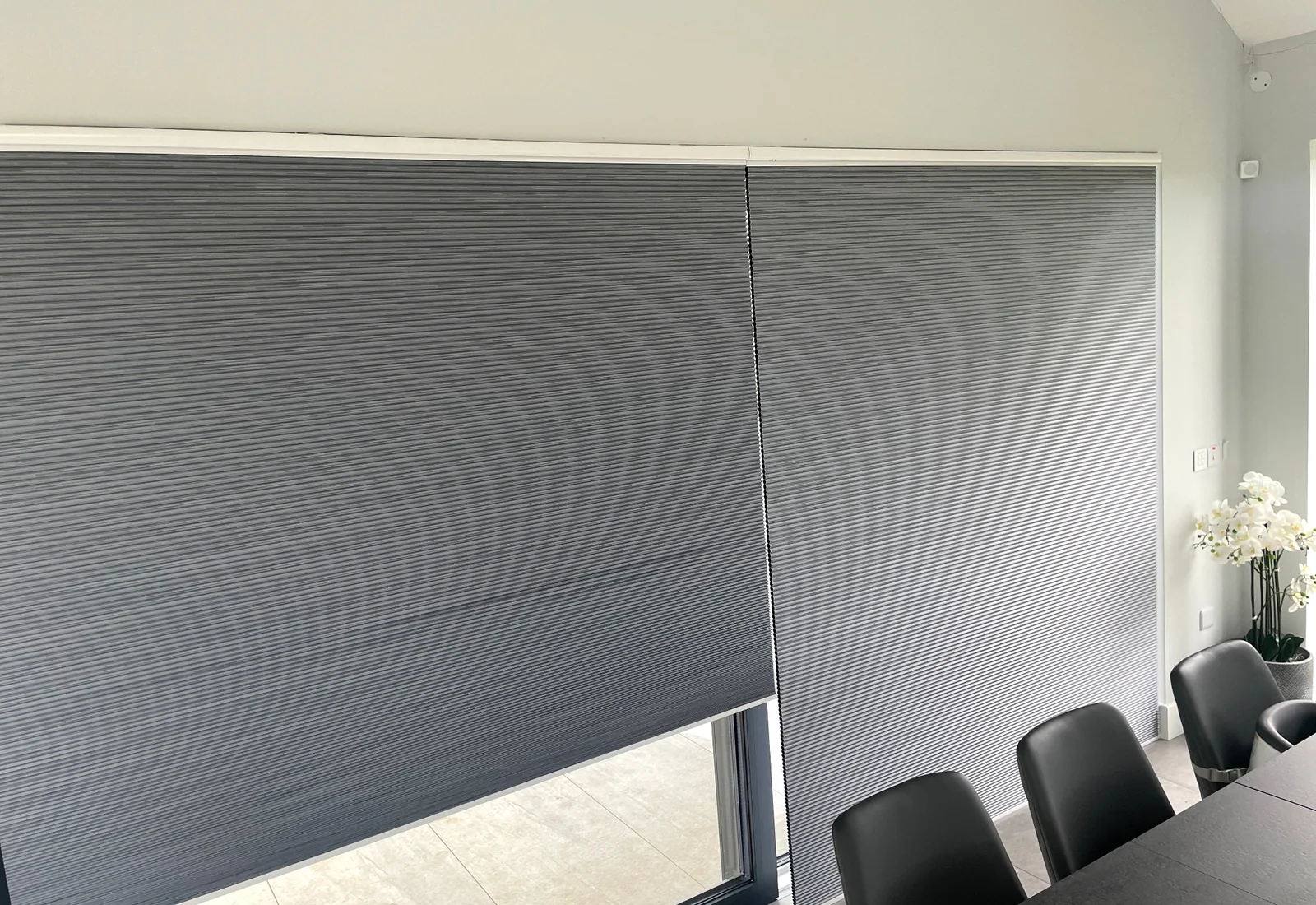 Dark grey cellular blinds fitted across a large glazed opening