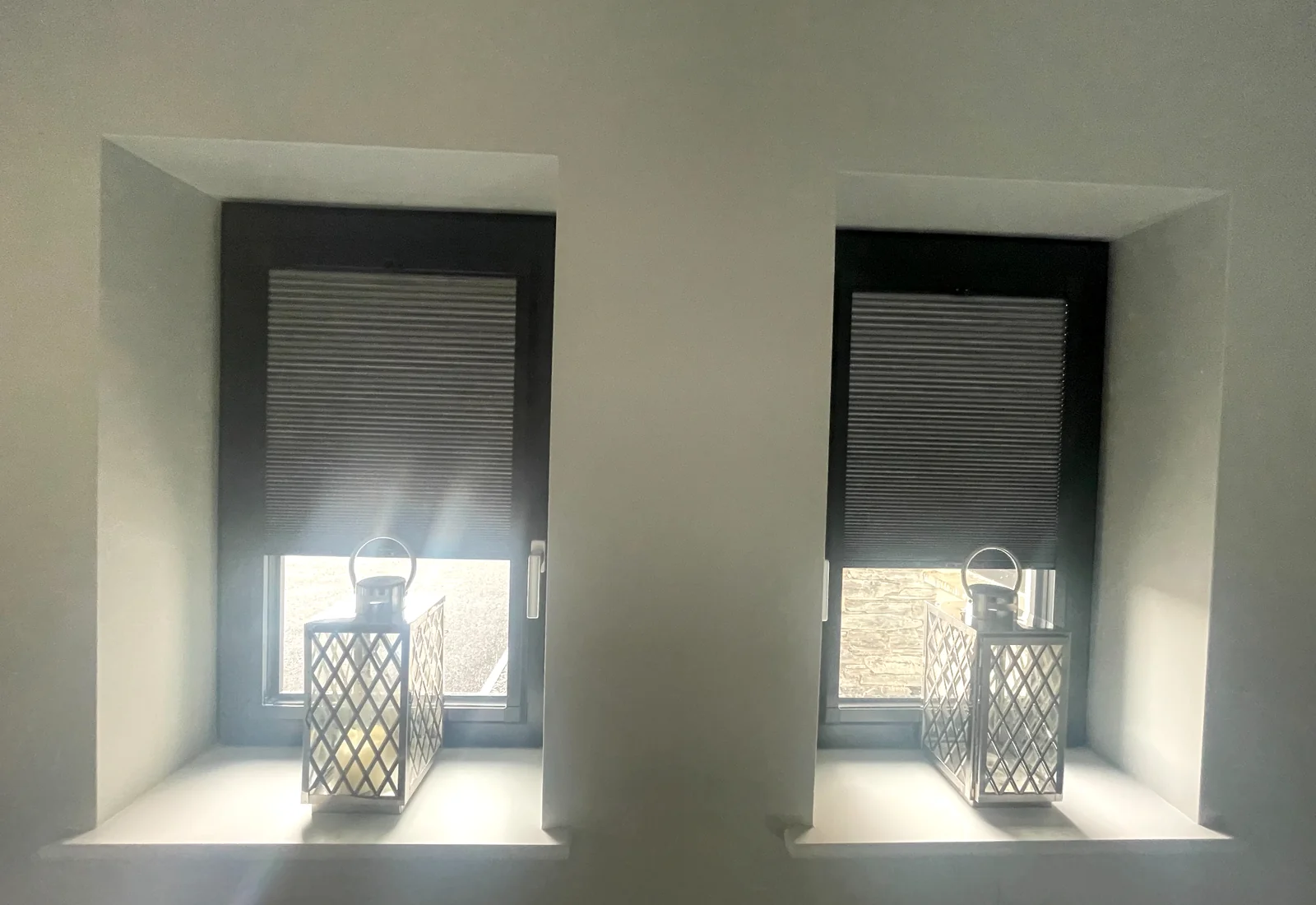Dark cellular blinds fitted to two small windows for stronger light control