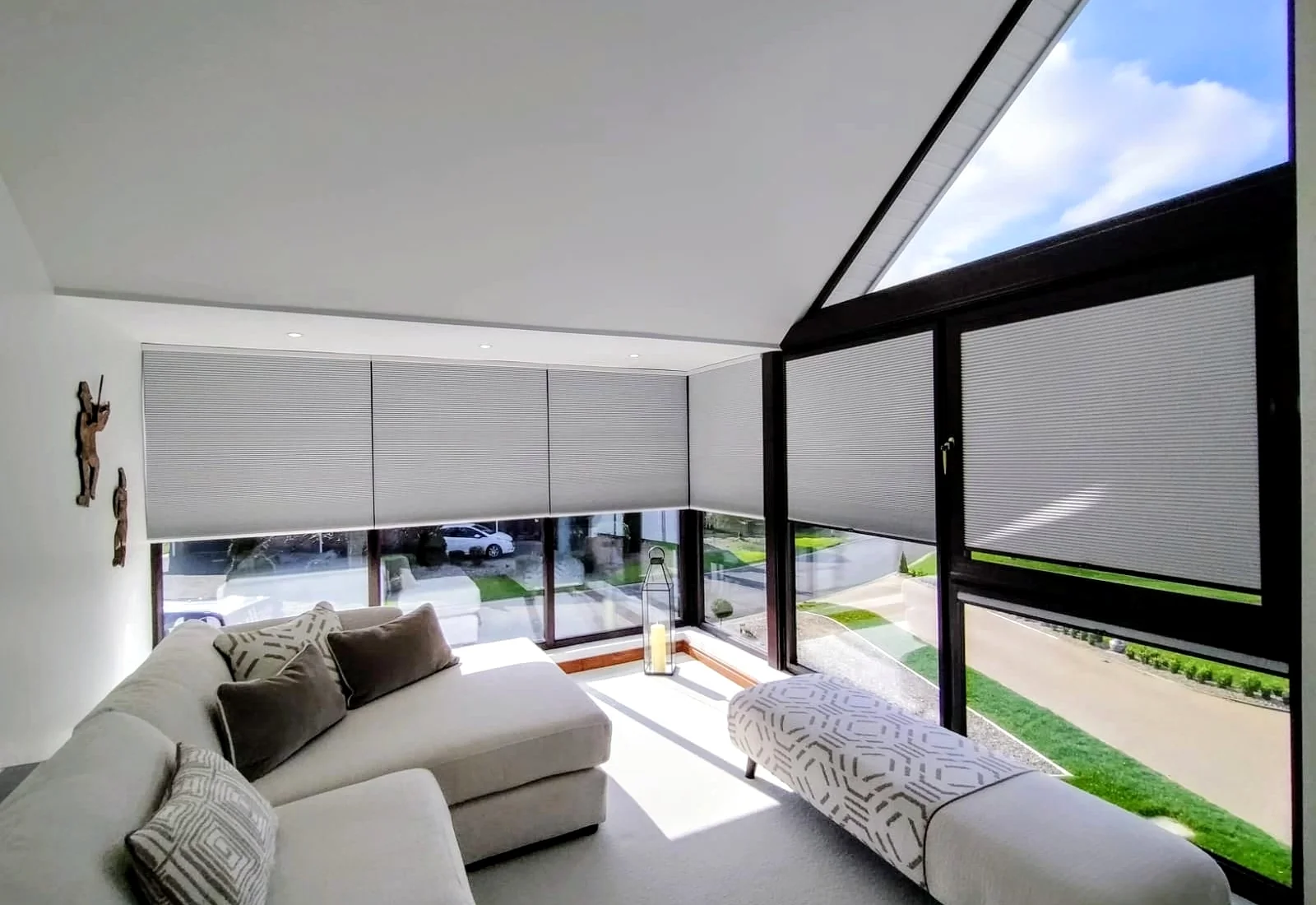 White cellular blinds filtering daylight across timber-framed glazing