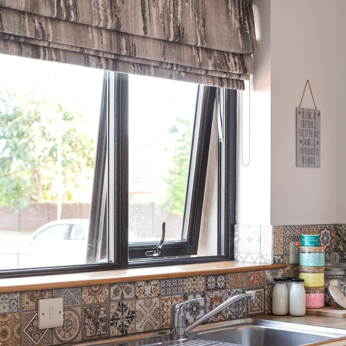 Soft Roman blind fitted over a kitchen window