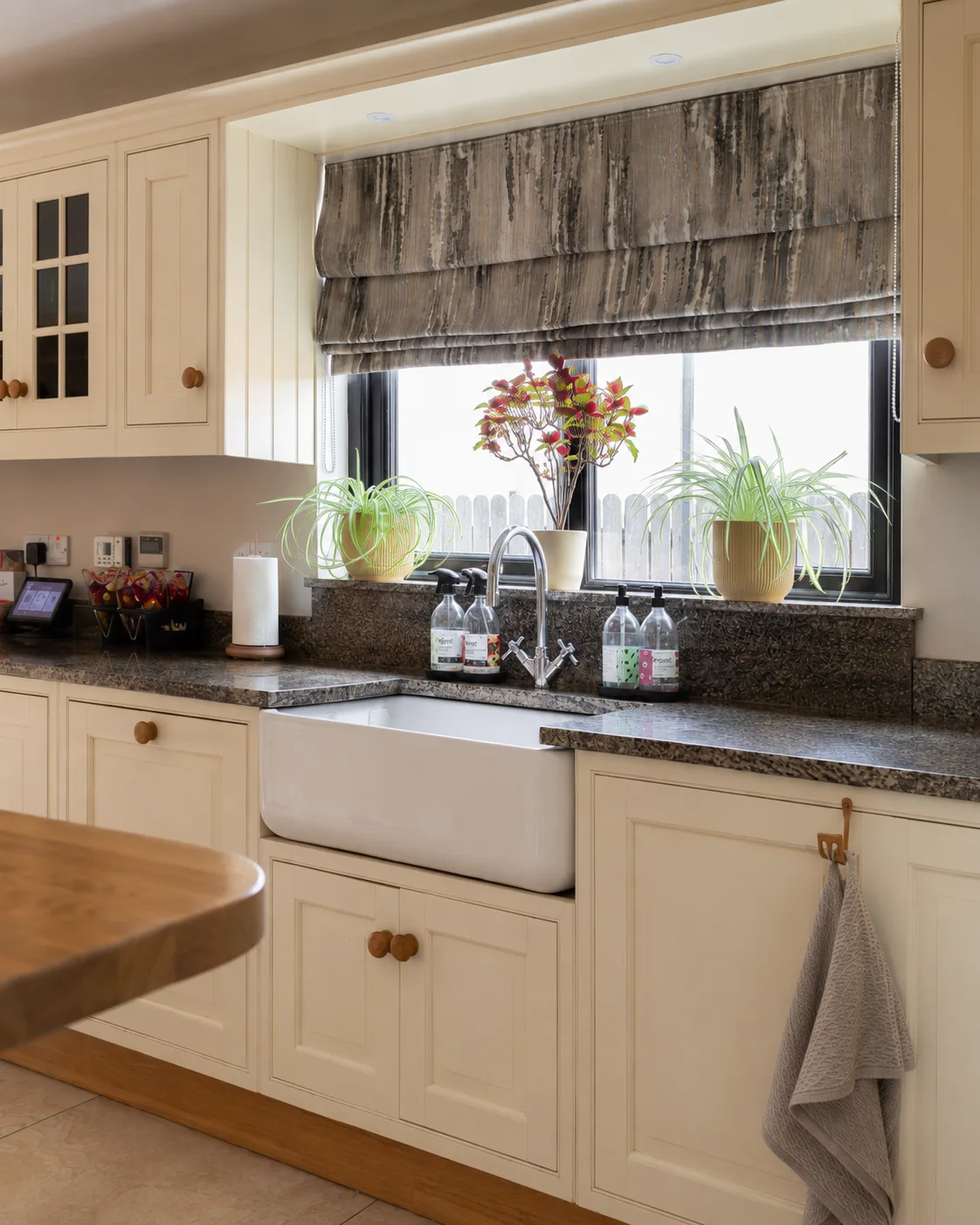 Patterned Roman blind fitted above a kitchen sink
