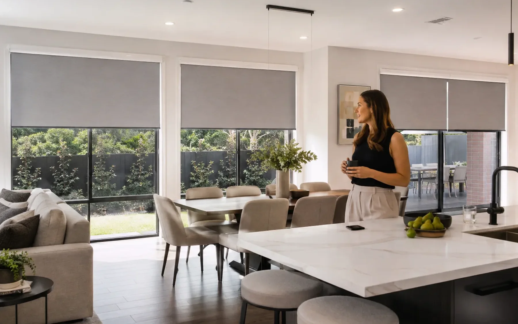 Open-plan home with several motorised roller blinds adjusted together