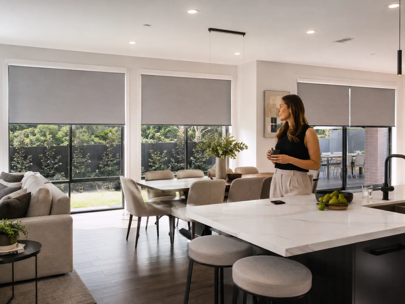 Open-plan kitchen and dining room with several motorised blinds adjusted together