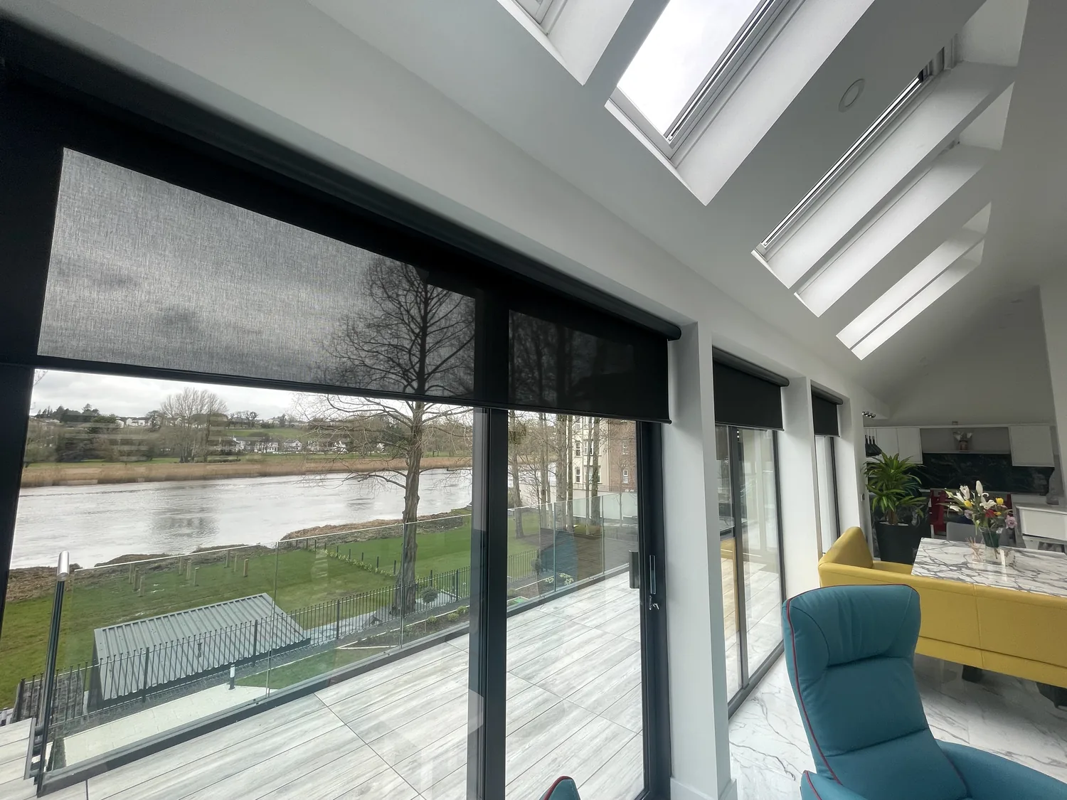 Motorised roller blinds fitted to large glazed doors and windows