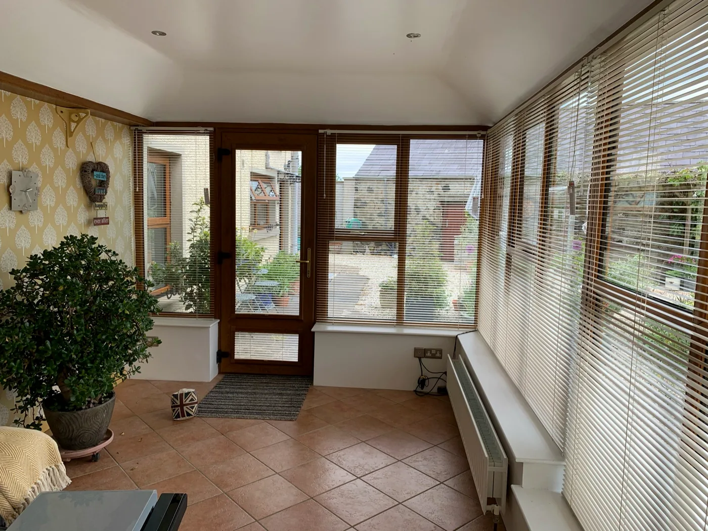 Warm Venetian blinds fitted around windows and a glazed door