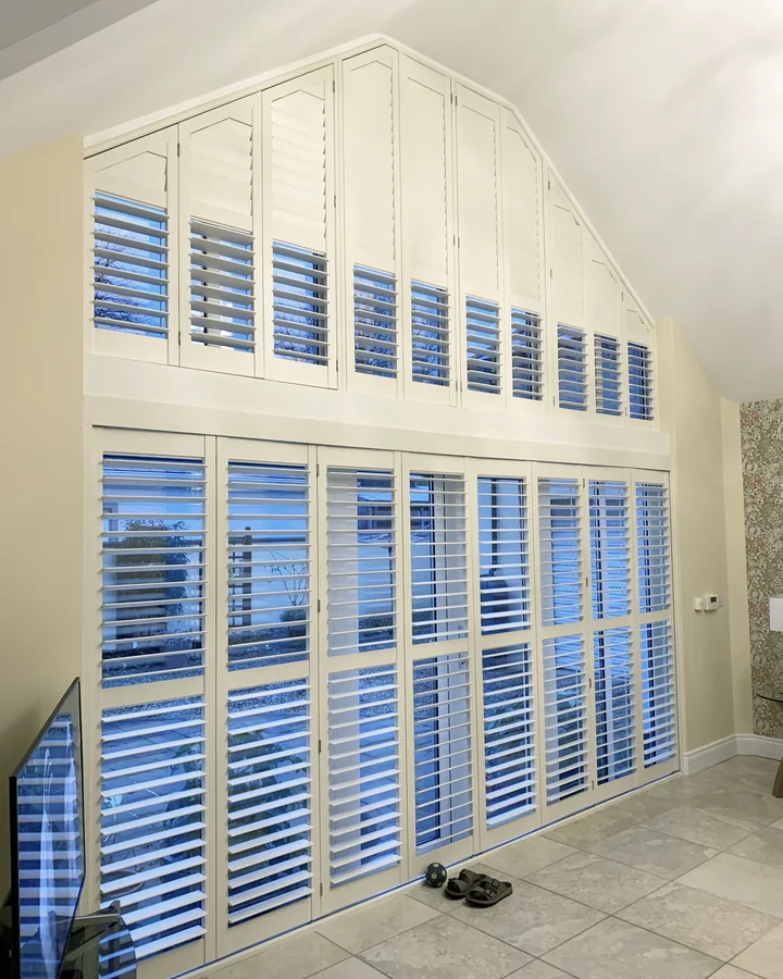 Large apex window with shutters following the sloping upper glazing