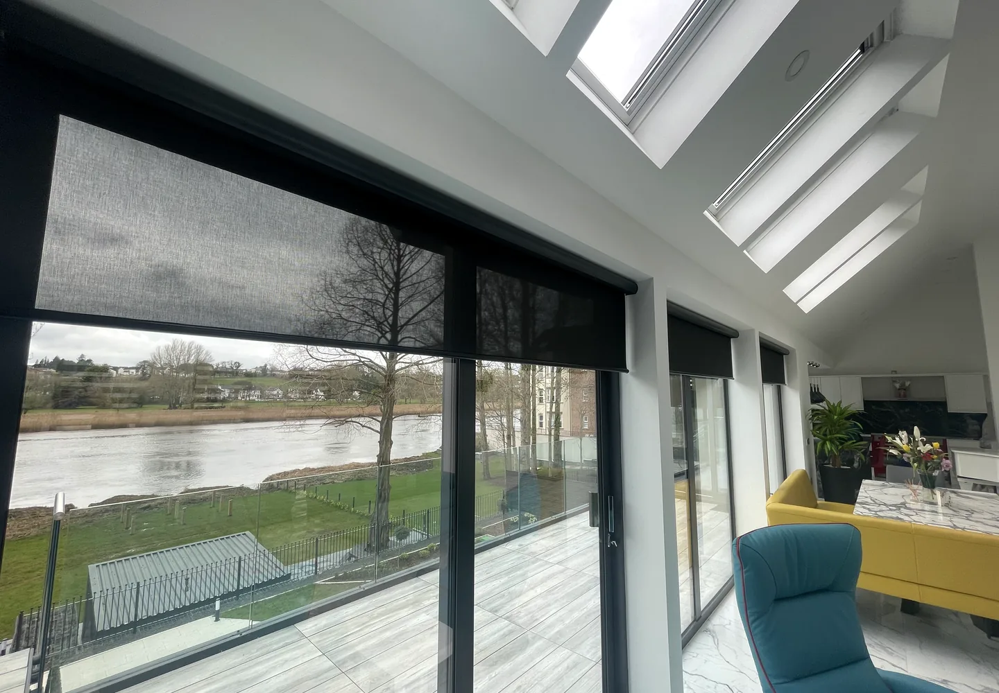 Motorised blinds installed across a large glazed living space in Northern Ireland