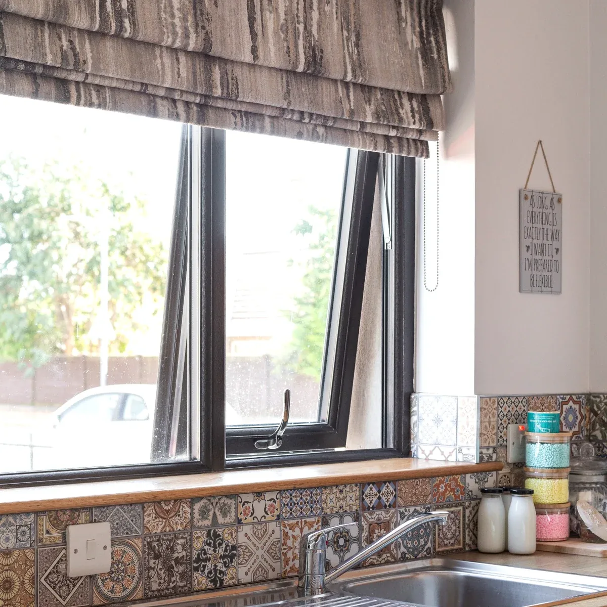 Motorised Roman blind fitted in a kitchen window
