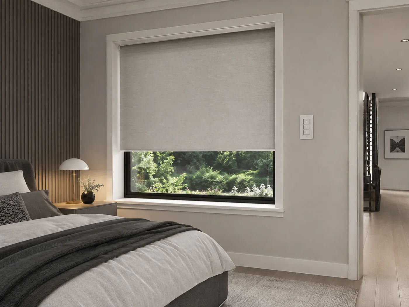 Motorised blind with a wall-mounted control in a modern bedroom
