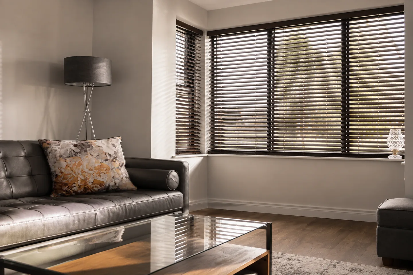 Illustrative living room with Venetian blind slats angled to soften direct sunlight while retaining daylight