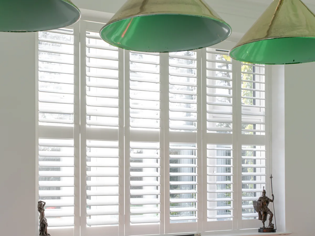 Full height plantation shutters fitted across a large window