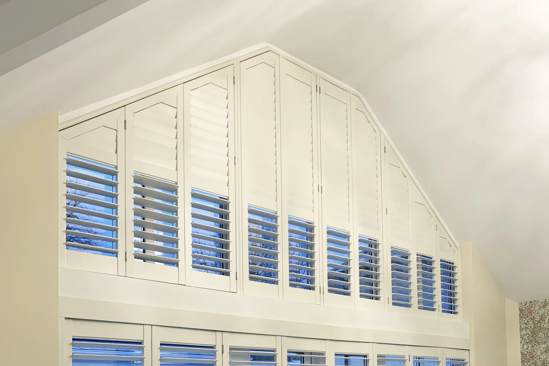 Made-to-measure plantation shutters fitted to an unusual shaped window