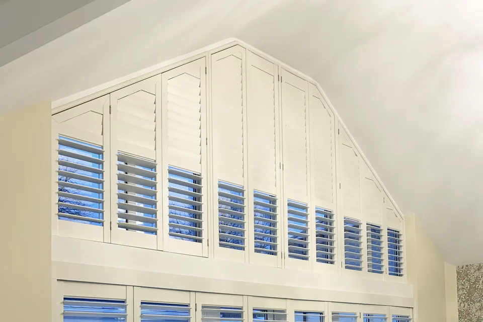 Made-to-measure shutters fitted to a large shaped apex window