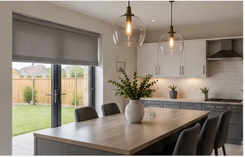 Contemporary kitchen and dining space with large glazed doors and a tailored Roman blind, illustrative of a home at The Spires in Dungannon.