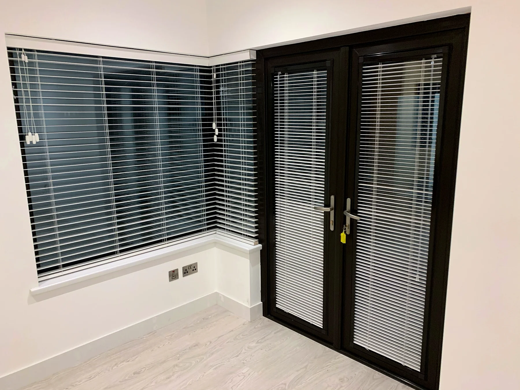 Wooden Venetian blinds and Perfect Fit aluminium blinds used together in a bright living space